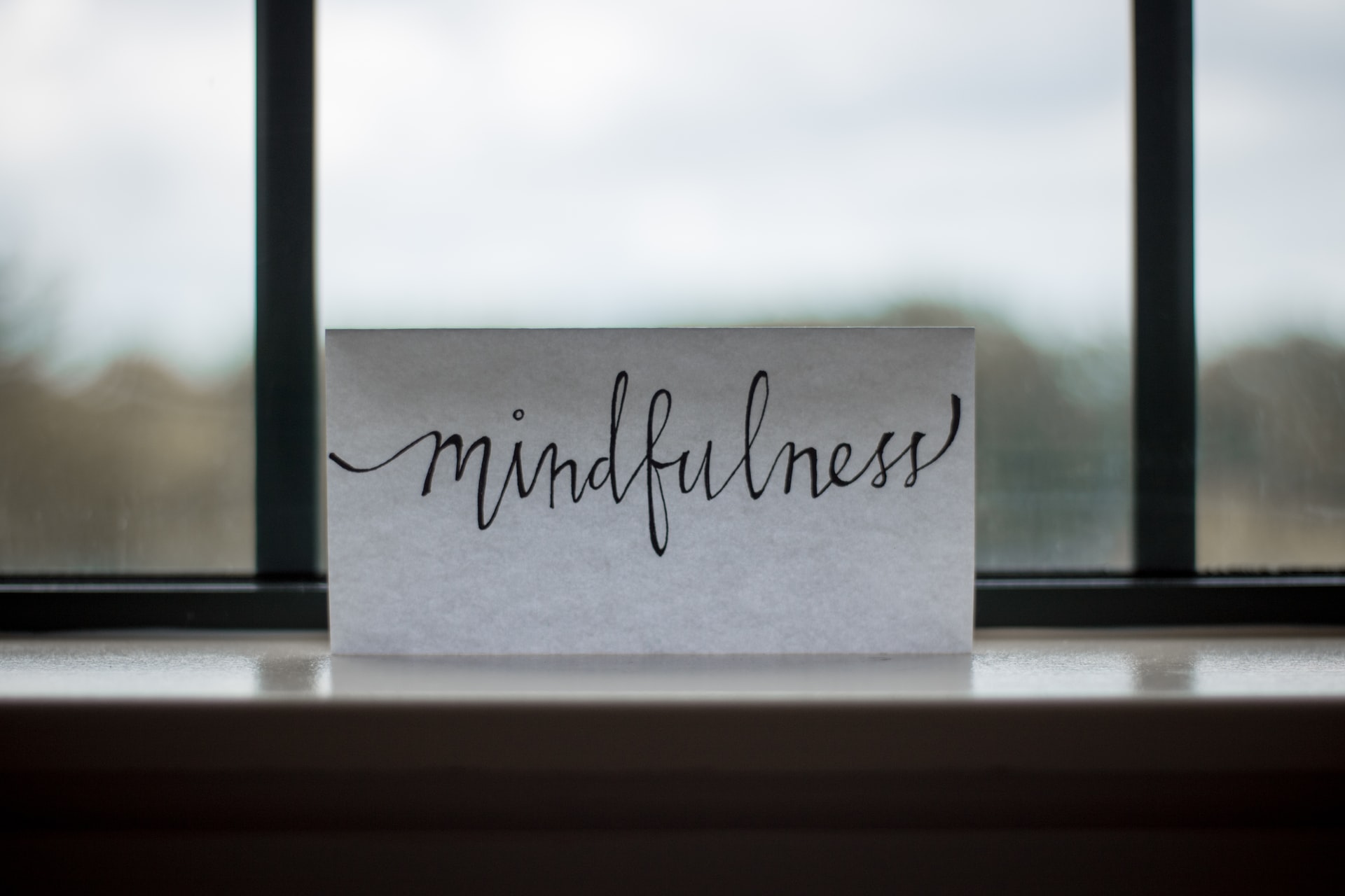 A piece of paper with 'mindfulness' written on it.